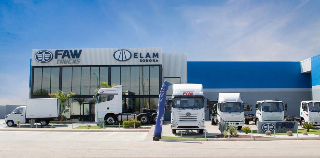 Fachada de la agencia FAW Trucks de Grupo Step en Hermosillo, Sonora, con unidades de carga ligera y pesada en piso